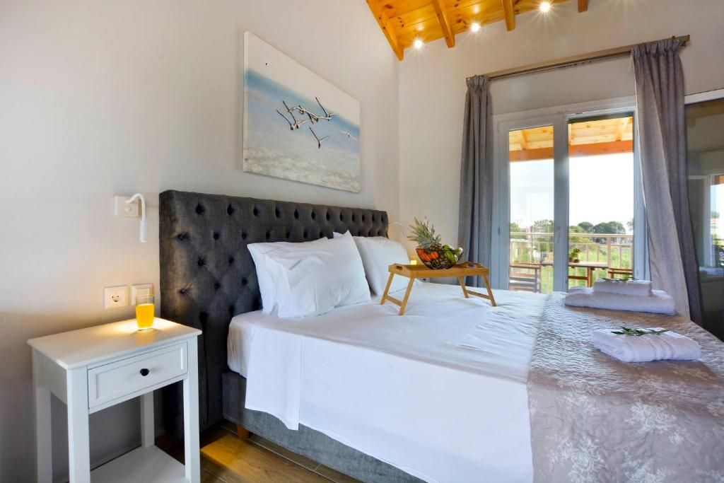 Bedroom 1 with a double bed, wooden ceiling and balcony door
